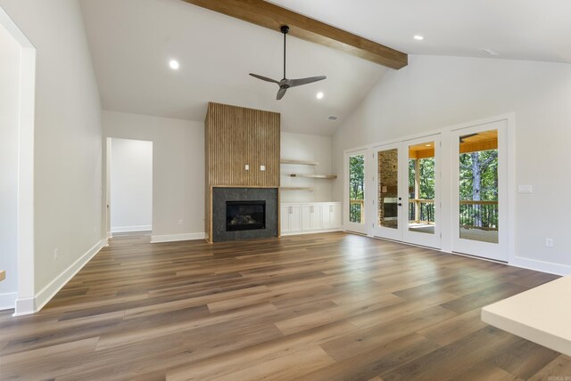 unfurnished living room with beam ceiling, a fireplace, high vaulted ceiling, wood-type flooring, and ceiling fan