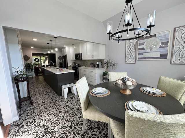 dining area with sink and a notable chandelier