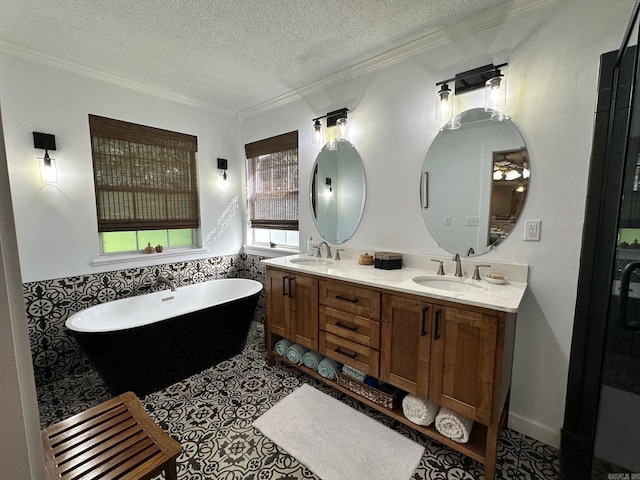 bathroom featuring a washtub, ornamental molding, vanity, tile patterned flooring, and a textured ceiling