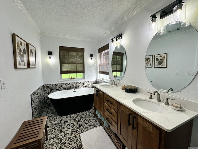 bathroom with a washtub, crown molding, a textured ceiling, and vanity