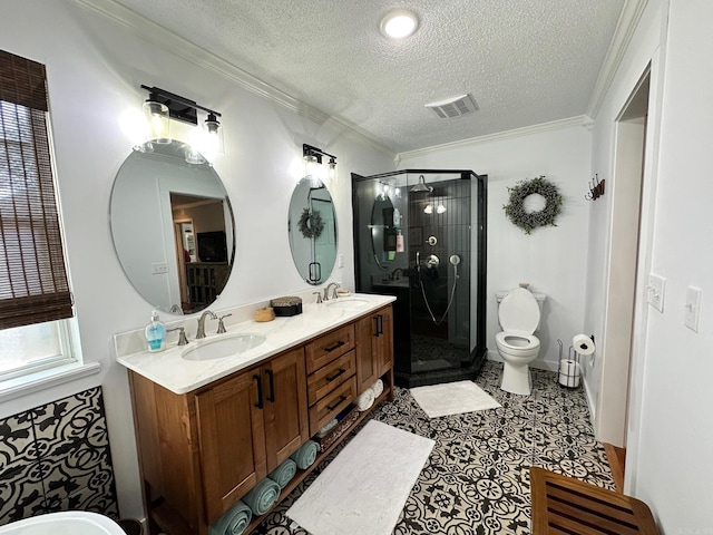 bathroom featuring a shower with door, toilet, vanity, a textured ceiling, and crown molding