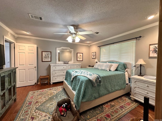 bedroom featuring dark hardwood / wood-style flooring, ornamental molding, a textured ceiling, and ceiling fan