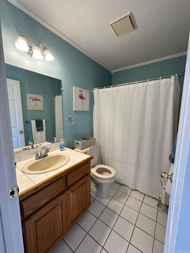 bathroom with tile patterned flooring, a textured ceiling, vanity, and toilet