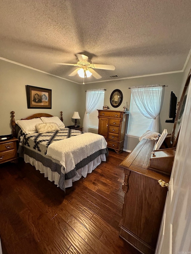 bedroom featuring ceiling fan, dark wood-type flooring, a textured ceiling, and ornamental molding