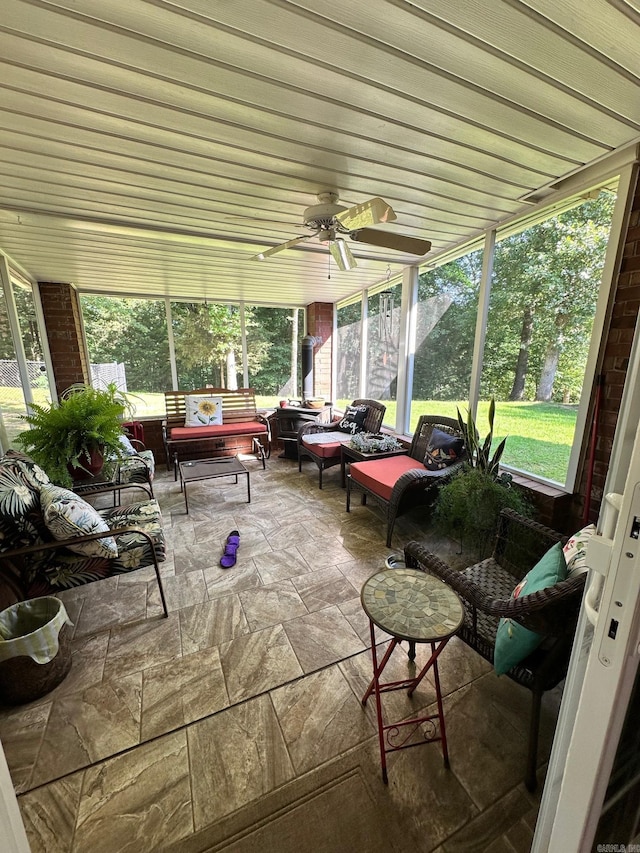 sunroom / solarium with ceiling fan and a wealth of natural light