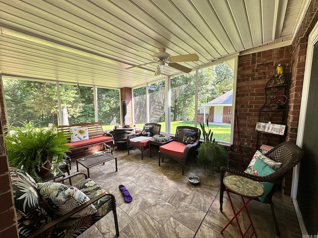 sunroom with a wealth of natural light and ceiling fan