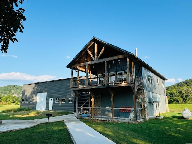 back of house with a patio area and a lawn