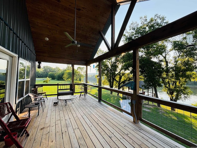 wooden terrace with a lawn and ceiling fan