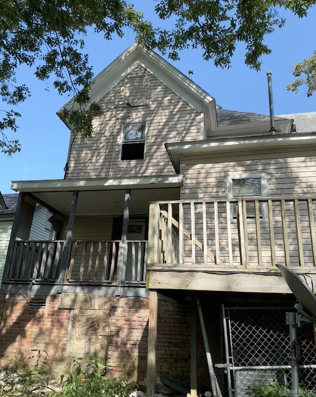 back of house featuring a balcony