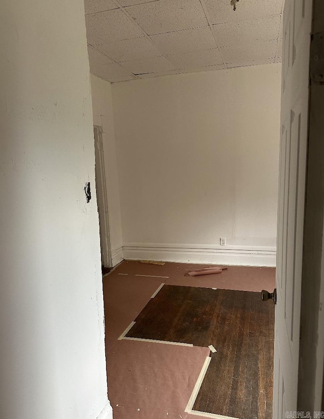 unfurnished room featuring a paneled ceiling and wood finished floors