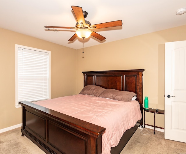 bedroom with ceiling fan and light colored carpet