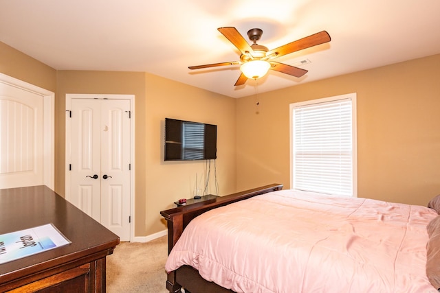 bedroom featuring light colored carpet and ceiling fan