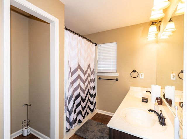 1107 Fox Chase Dr, Bryant, AR 72022 - bathroom featuring double vanity, baseboards, a sink, and a shower with curtain