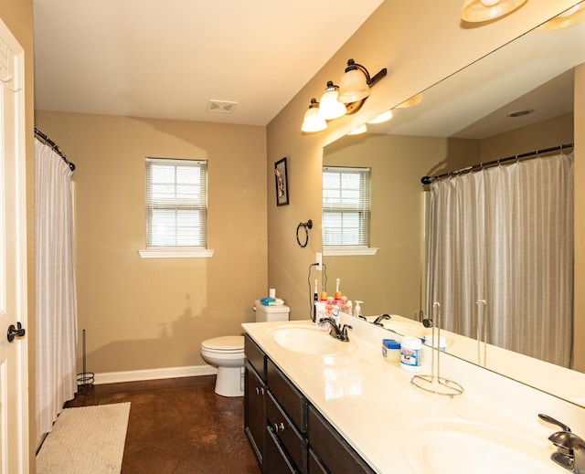 bathroom featuring tile patterned flooring, vanity, and toilet