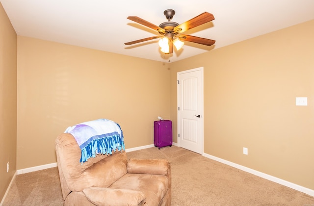 sitting room featuring ceiling fan and light colored carpet