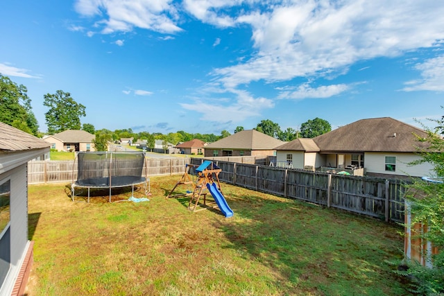 view of yard featuring a trampoline and a playground