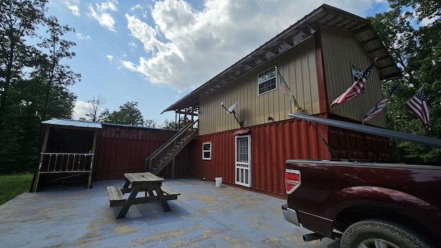 back of house featuring stairs and a patio area