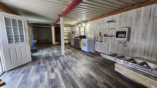 kitchen with dark wood-type flooring, heating unit, and white range with gas cooktop