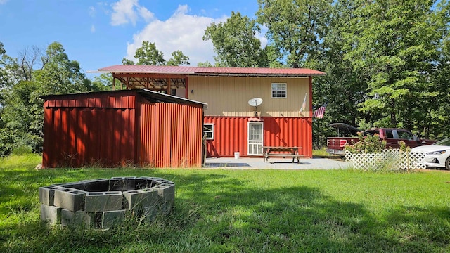 rear view of property featuring a lawn