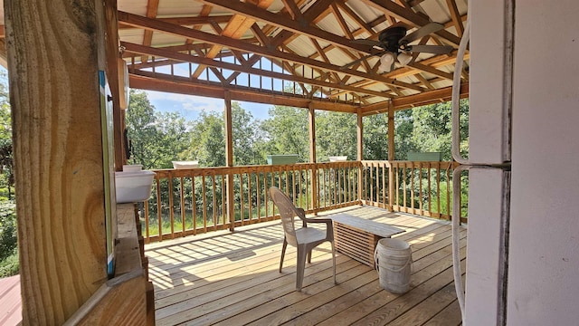 sunroom with vaulted ceiling and a ceiling fan