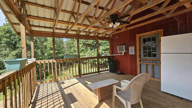 wooden terrace featuring ceiling fan and a wall mounted AC