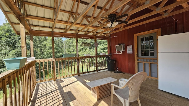 wooden deck with a ceiling fan and a wall mounted air conditioner