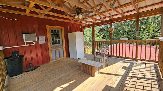 sunroom featuring ceiling fan and a wall unit AC