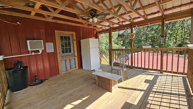 wooden terrace with a ceiling fan and a wall mounted AC