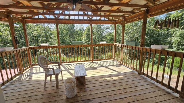 wooden deck featuring ceiling fan