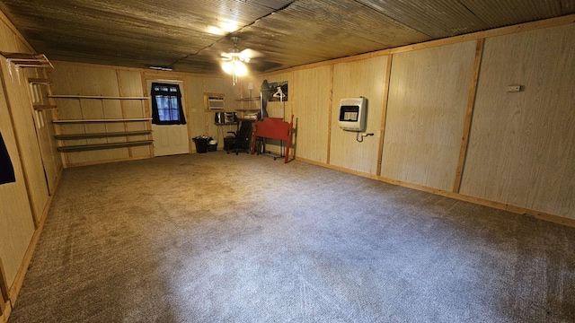 basement featuring heating unit, wooden ceiling, wooden walls, and carpet flooring