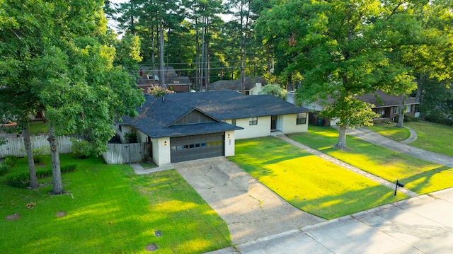 view of front of property featuring a front lawn and a garage