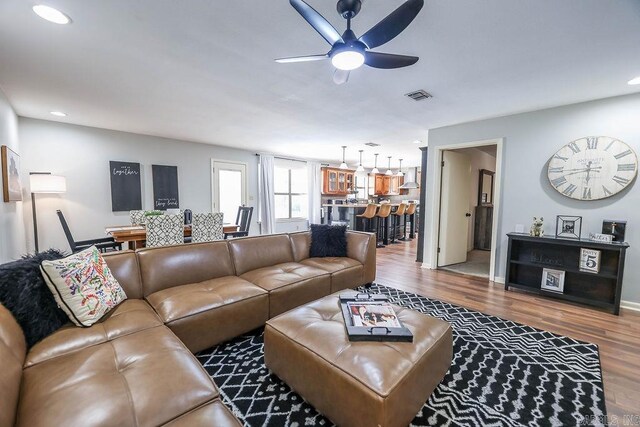 living room featuring ceiling fan and wood-type flooring