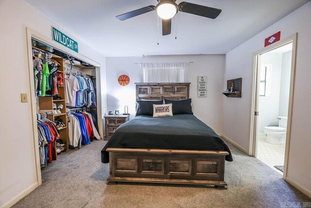 bedroom featuring a closet, ceiling fan, ensuite bathroom, and carpet flooring