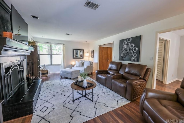 living room featuring hardwood / wood-style flooring and a premium fireplace