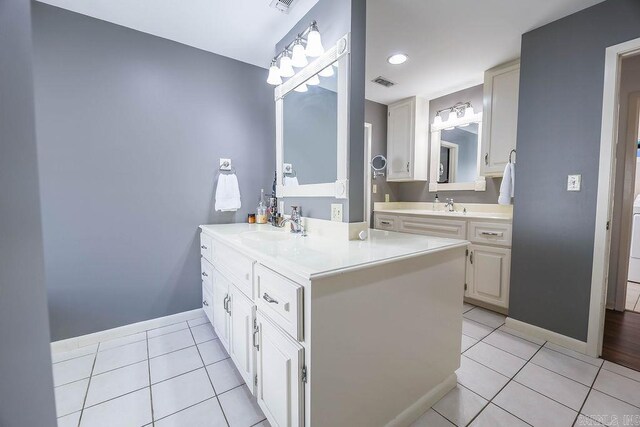 bathroom featuring tile patterned flooring and vanity