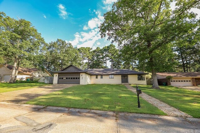 ranch-style home with a garage and a front yard