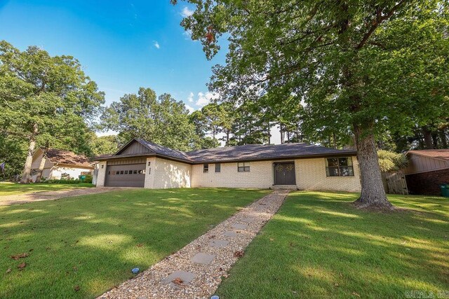 ranch-style home featuring a garage and a front yard