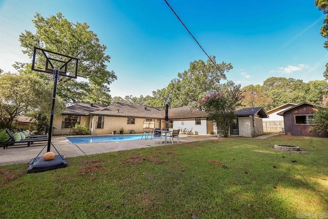 exterior space with a yard, a fire pit, and an outdoor structure