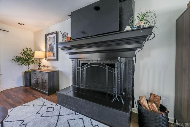 interior details featuring a fireplace and hardwood / wood-style floors