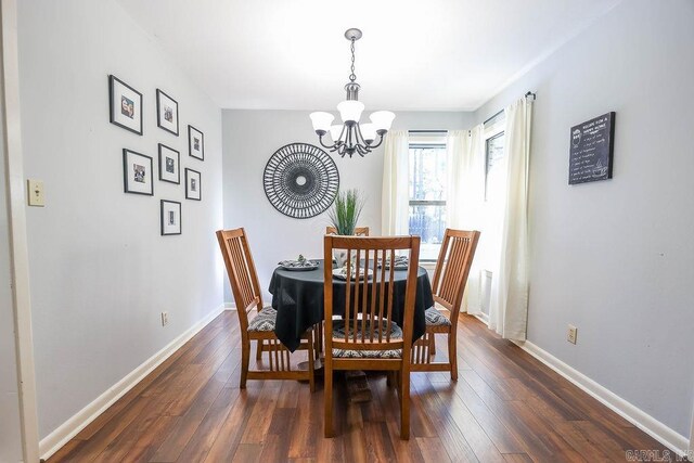 dining space with an inviting chandelier and dark hardwood / wood-style floors