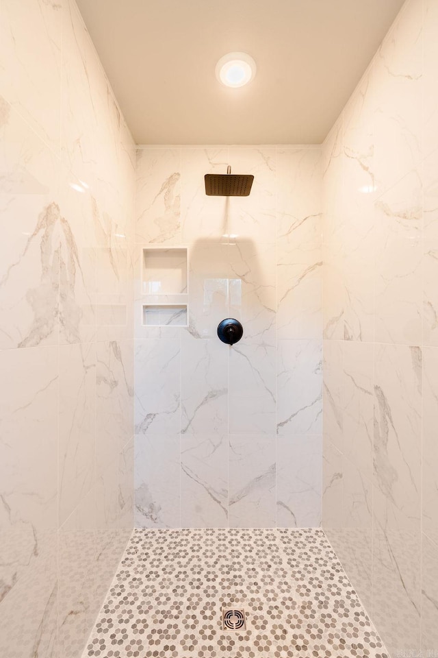 bathroom with a marble finish shower