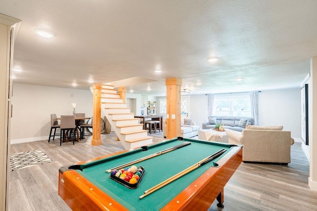 recreation room featuring billiards, a textured ceiling, baseboards, and wood finished floors