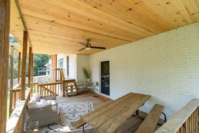 wooden terrace featuring ceiling fan and outdoor dining area