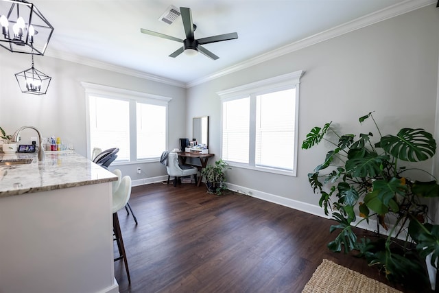 home office featuring ceiling fan with notable chandelier, dark wood-type flooring, ornamental molding, and sink