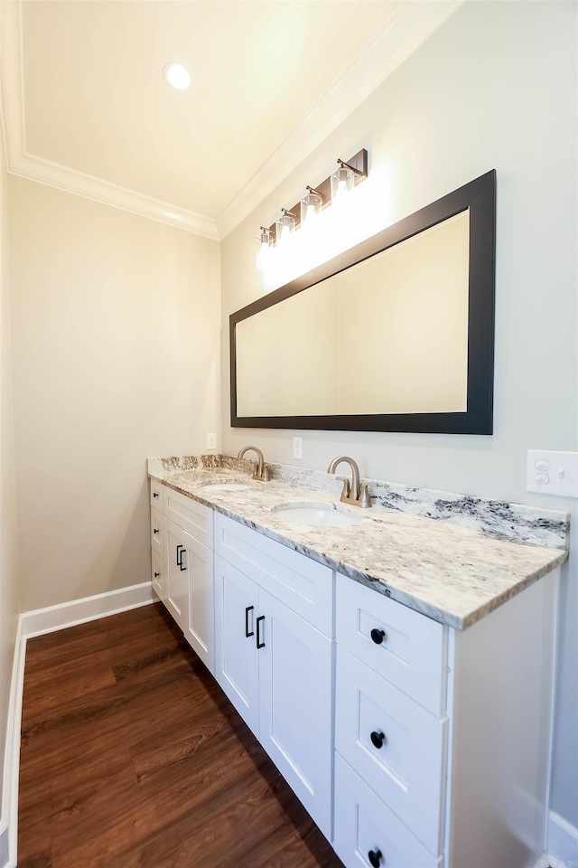 bathroom featuring vanity, crown molding, and wood-type flooring