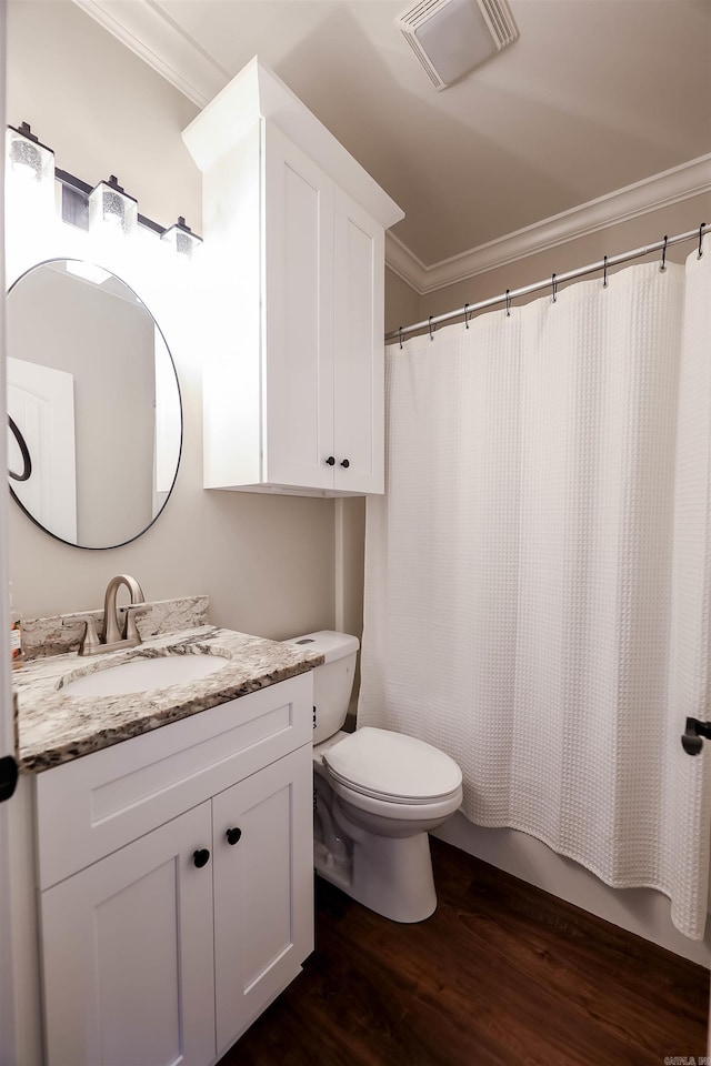 bathroom featuring toilet, crown molding, hardwood / wood-style floors, a shower with shower curtain, and vanity