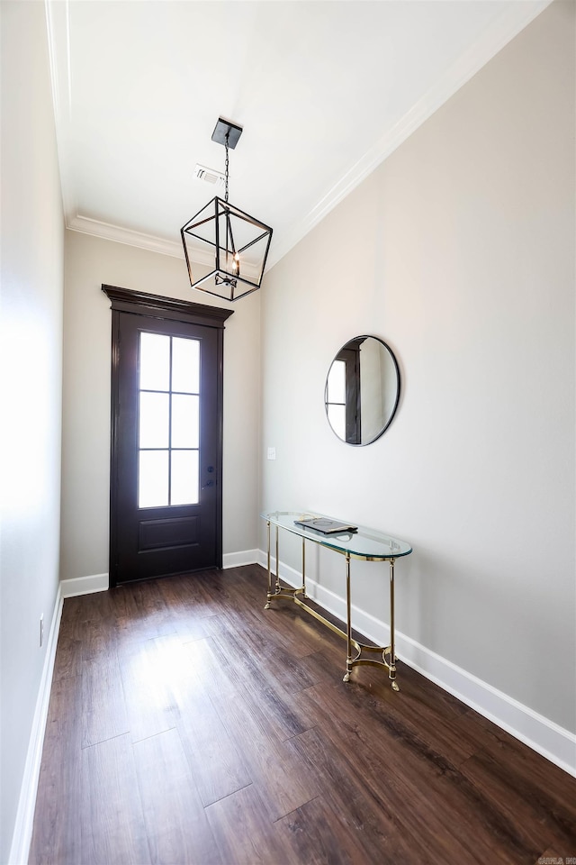 doorway featuring an inviting chandelier, dark hardwood / wood-style floors, and ornamental molding