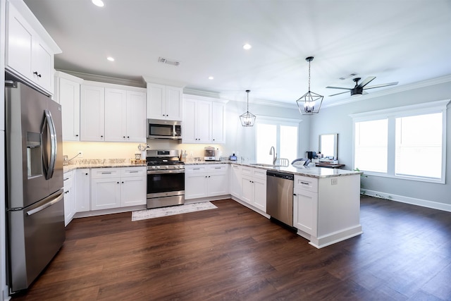 kitchen with decorative light fixtures, stainless steel appliances, white cabinetry, and kitchen peninsula