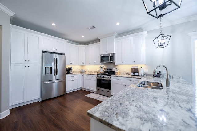 kitchen featuring sink, light stone counters, white cabinetry, decorative light fixtures, and stainless steel appliances