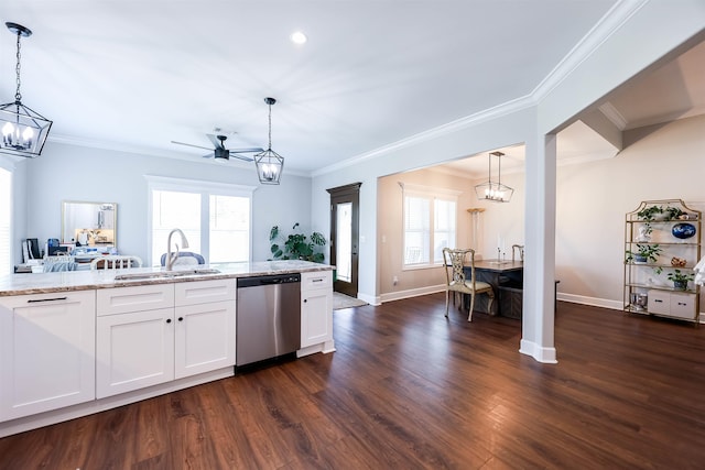 kitchen featuring white cabinetry, stainless steel dishwasher, sink, and hanging light fixtures